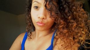 Close-Up Of Young Woman Looking Down While Puckering At Home