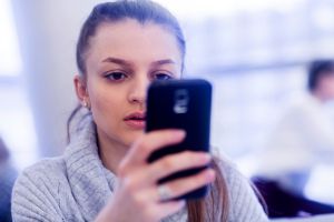 Portrait of young woman using smartphone
